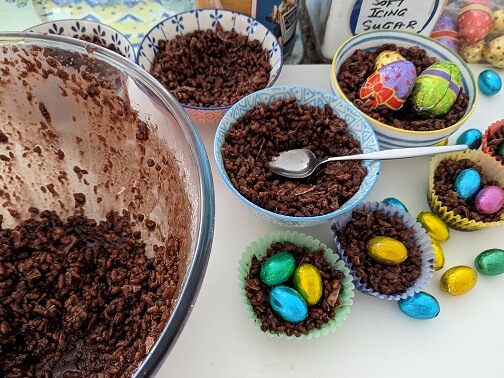 Spoon chocolate crackle mixture into bowls to make Easter egg nests