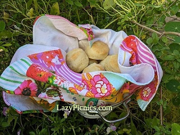 A colander with teatowel and scones
